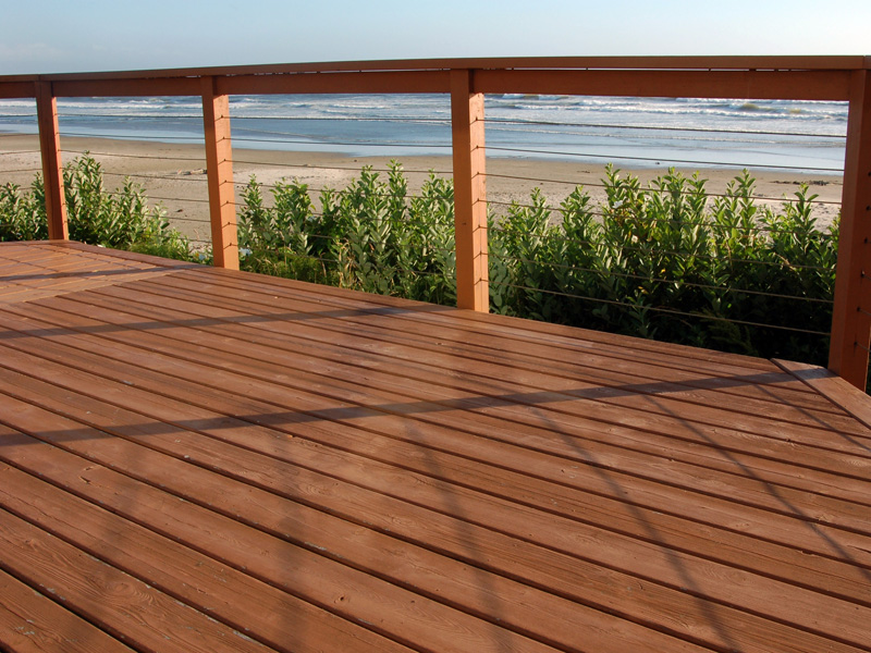 When is it safe to stain pressure-treated wood?